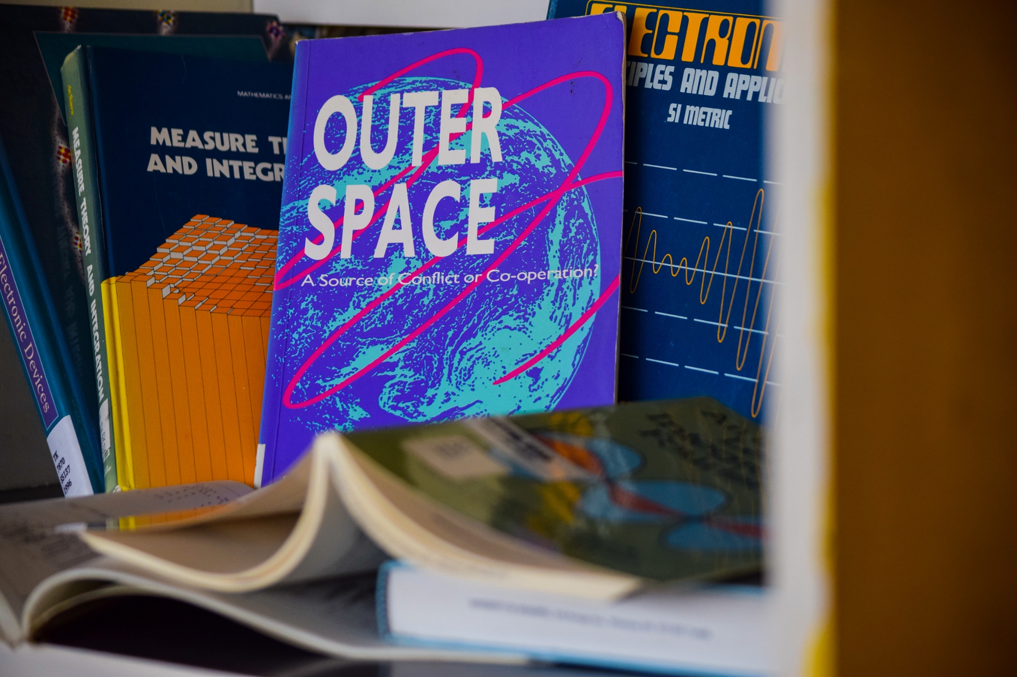 A display of vintage science titles; one reads, "Outer Space."
